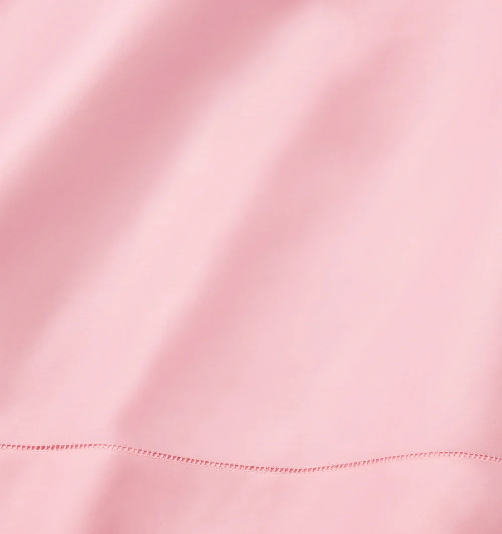 Close-up of pink satin fabric with a subtle sheen